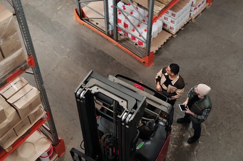 warehouse-workers-looking-at-shelves