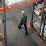 man walking through warehouse