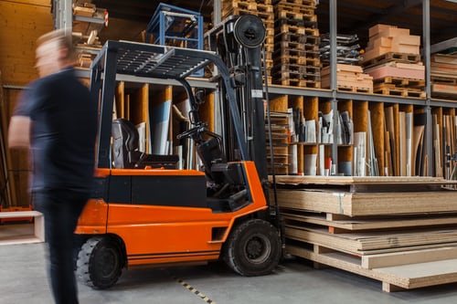 man walking away from forklift