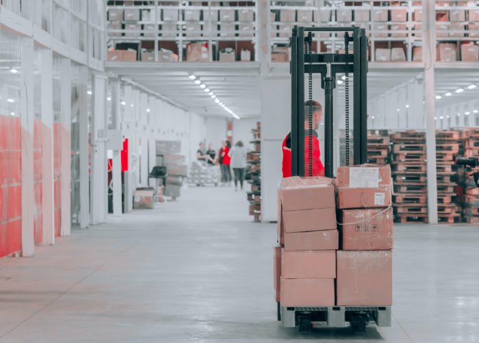 warehouse worker operating pallet jack